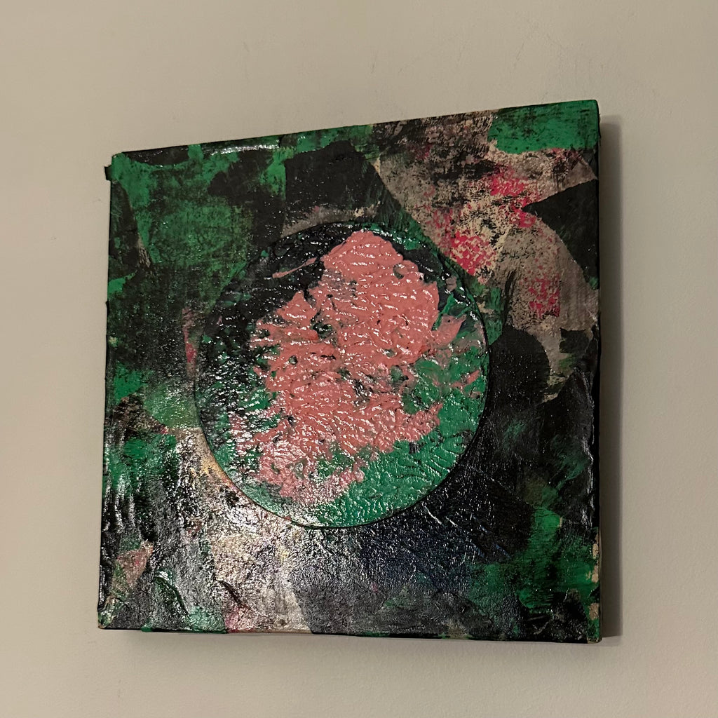 Eclipse I, rundt kunstverk i rosa og grønt på mørk collage, malt med akvarell og akryl, montert på treplate.